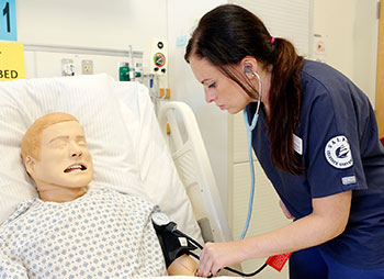 Salem State student with a manikin