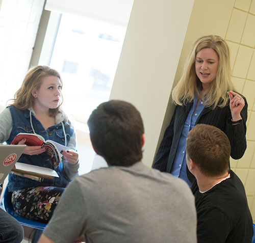 Worcester State Success Caoch talks to students in class